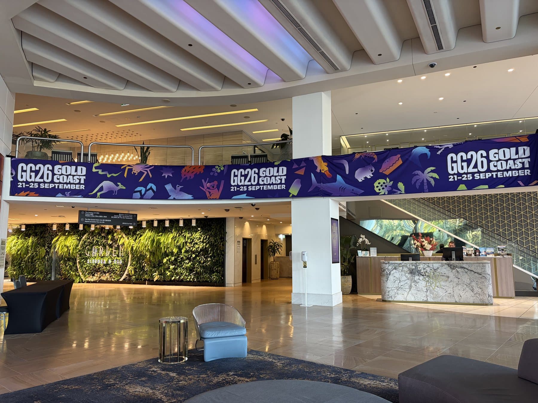 Printed fabric banner running the length of a hotel lobby balcony