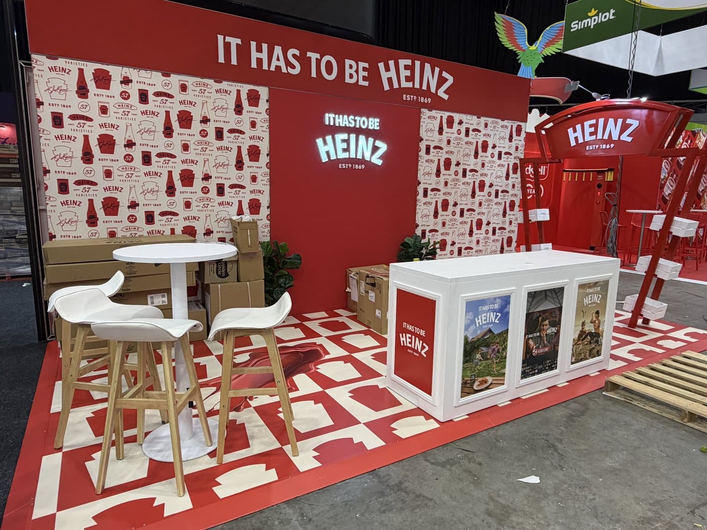 Exhibition stand with printed walls, counter and illuminated sign