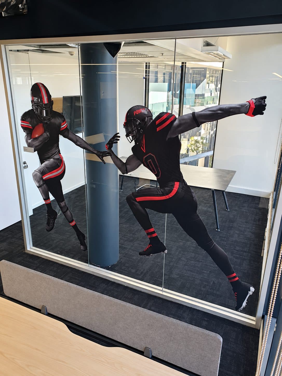 Cut figures applied to a glass office partition