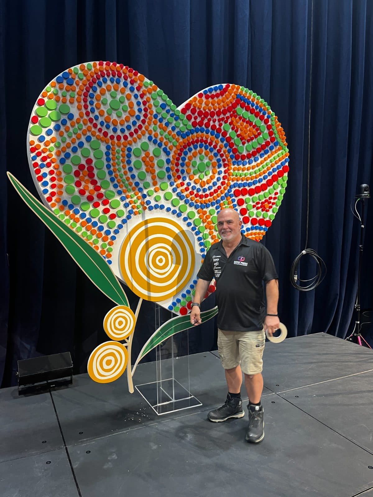 Heart shaped display build, shown with a member of the team for scale