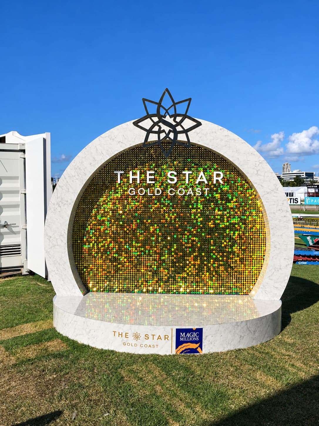 Branded event activation build with a sequin wall and printed surround