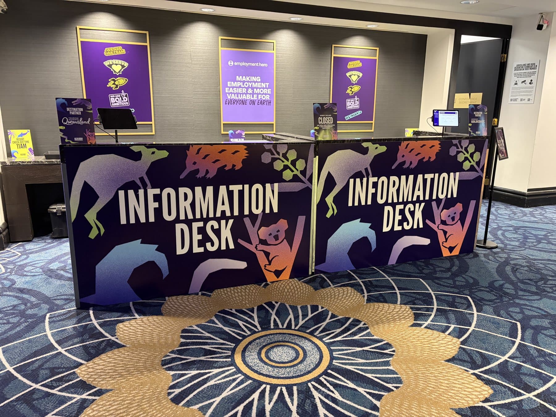 Conference information desks clad in printed panels