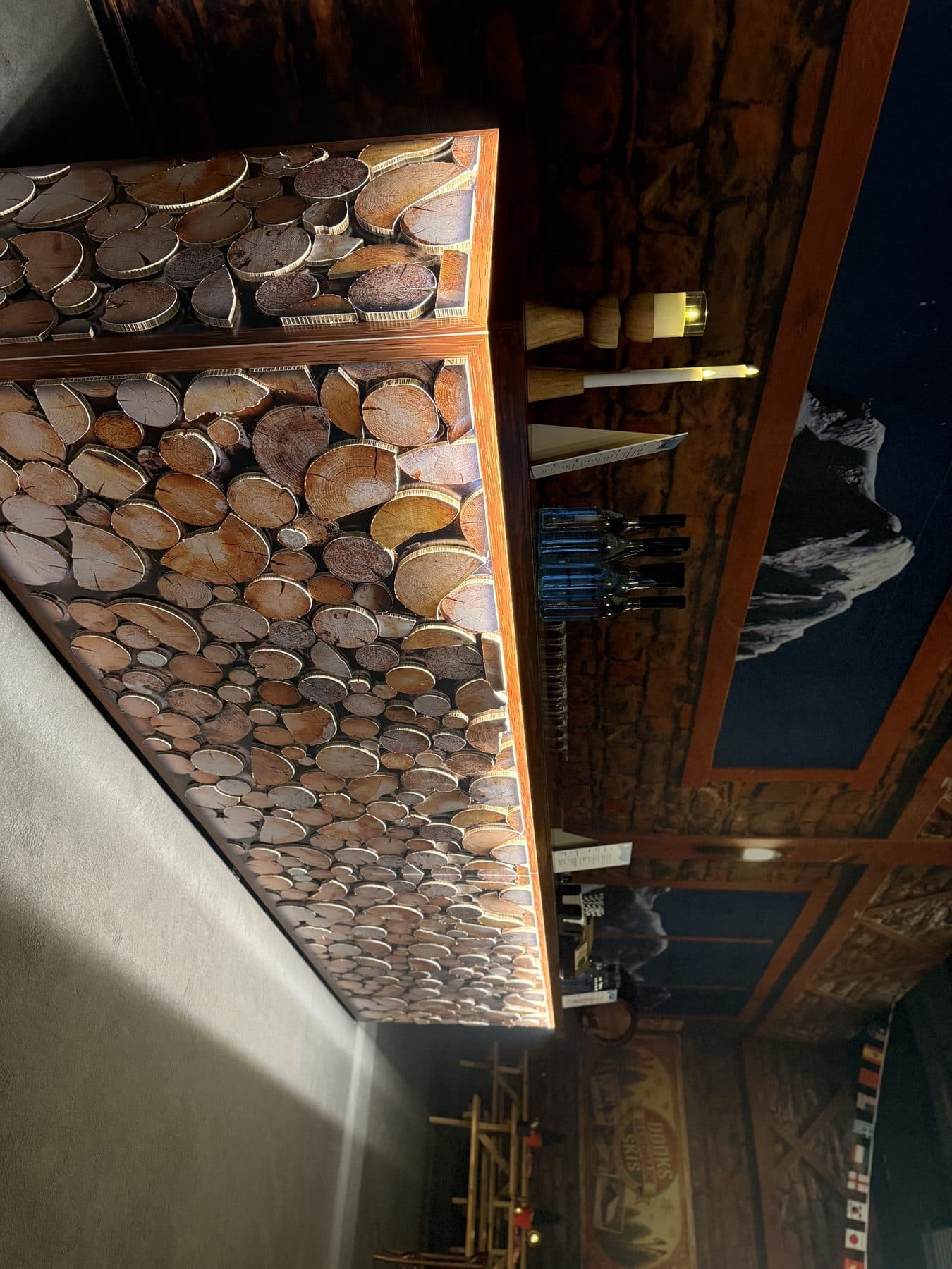 Bar facade clad in printed board, contour cut and layered in relief