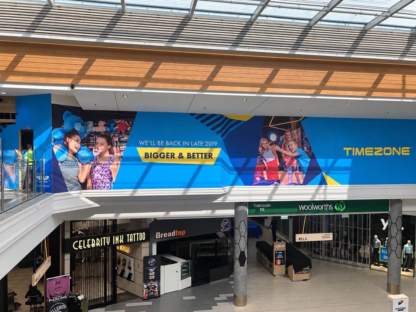 Printed hoarding wrap across a shopping centre tenancy